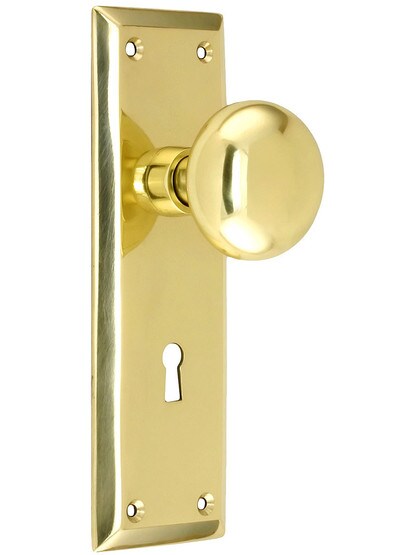 New York Style Door Set With Classic Round Knobs in Unlacquered Brass.